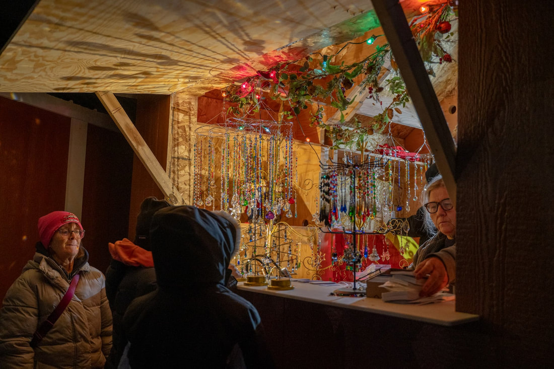 Shoppers browsing handcrafted goods in Downtown West Bend